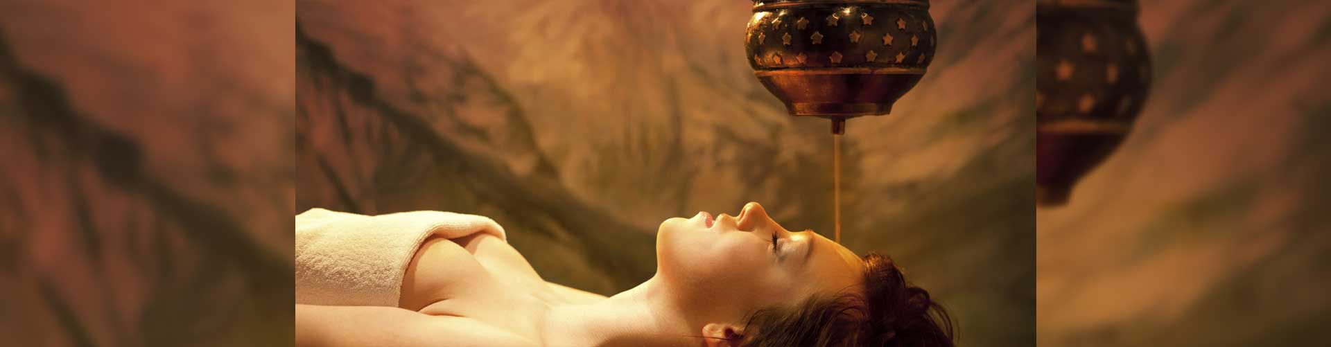 Woman relaxing in a candlelit spa room